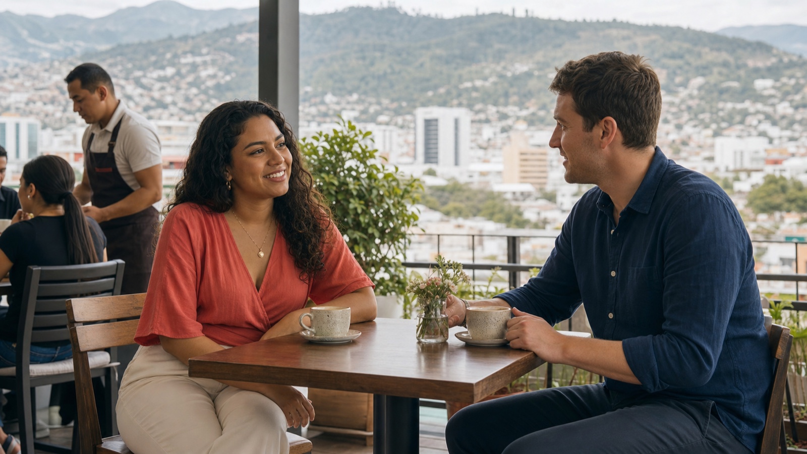 A Honduran woman and a foreign man meeting at a staffed daytime cafe in Tegucigalpa